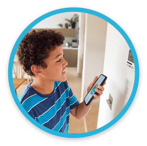 A Young Boy Adjusting the Thermostat From His Phone 